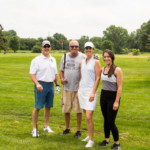 2018 FCC Annual Golf Tournament golfers posing together and smiling with clubs