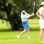 2018 FCC Annual Golf Tournament golfer striking the ball with iron