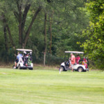 2018 FCC Annual Golf Tournament golfers in carts in the distance