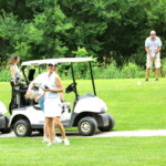 2018 FCC Annual Golf Tournament golfers in distance, smiling
