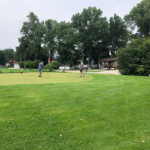 2018 FCC Annual Golf Tournament golfers in distance on the green